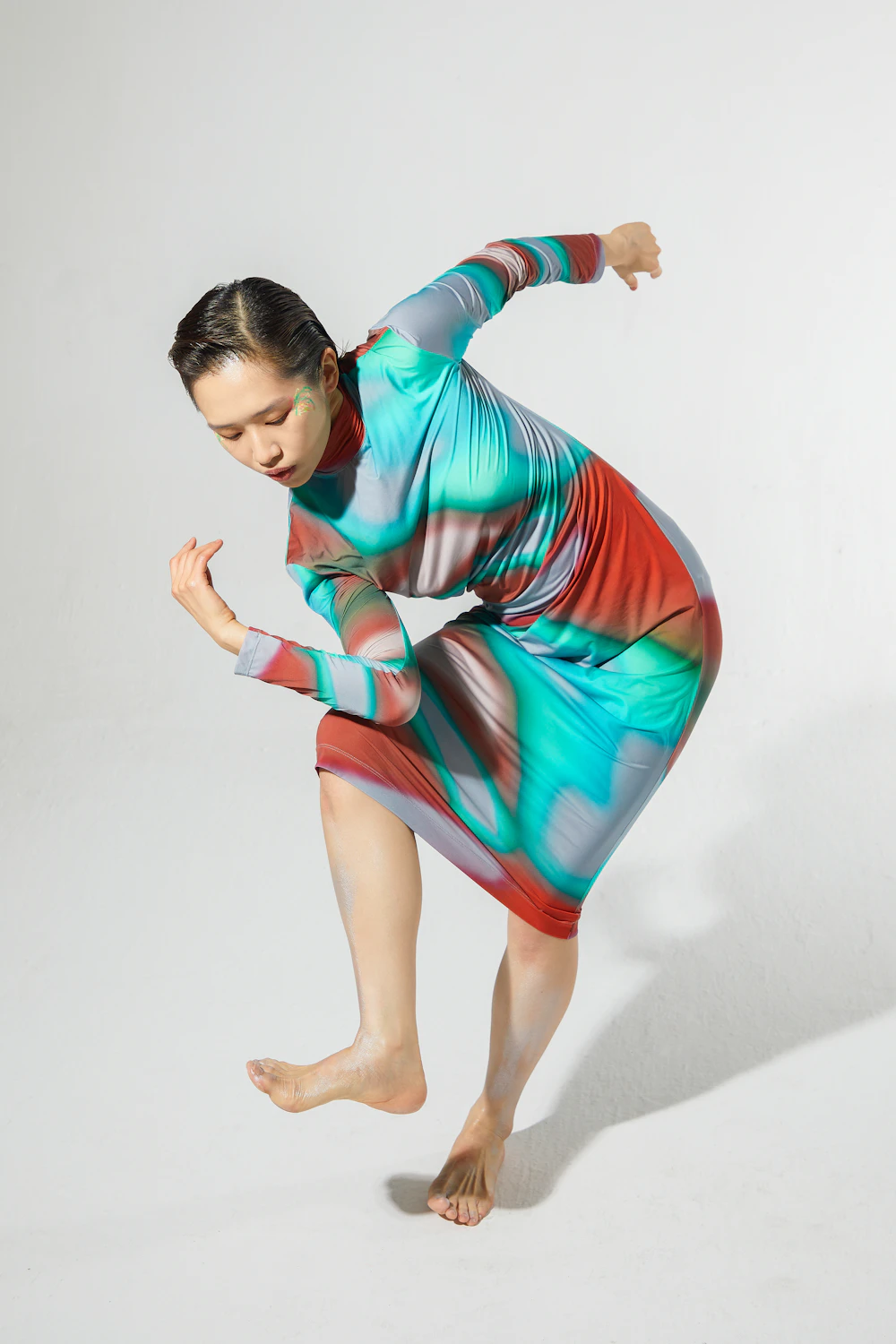 Dancer in a colourful dress mid-movement