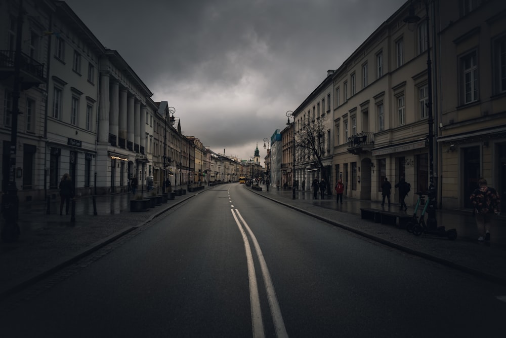 a dark street with buildings and people on it