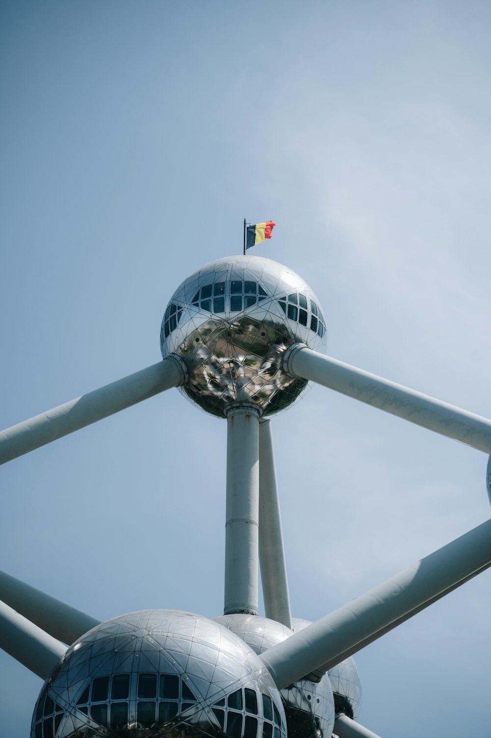 a large metal structure with a flag on top