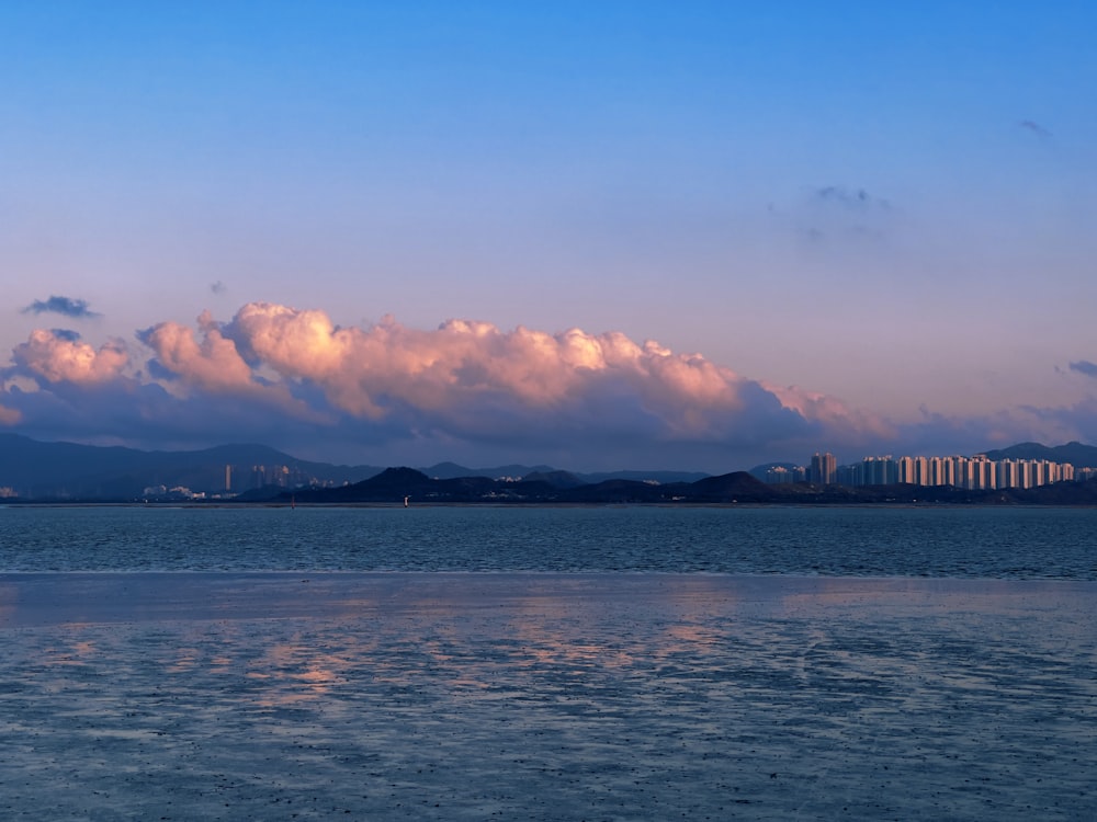 a large body of water under a cloudy sky