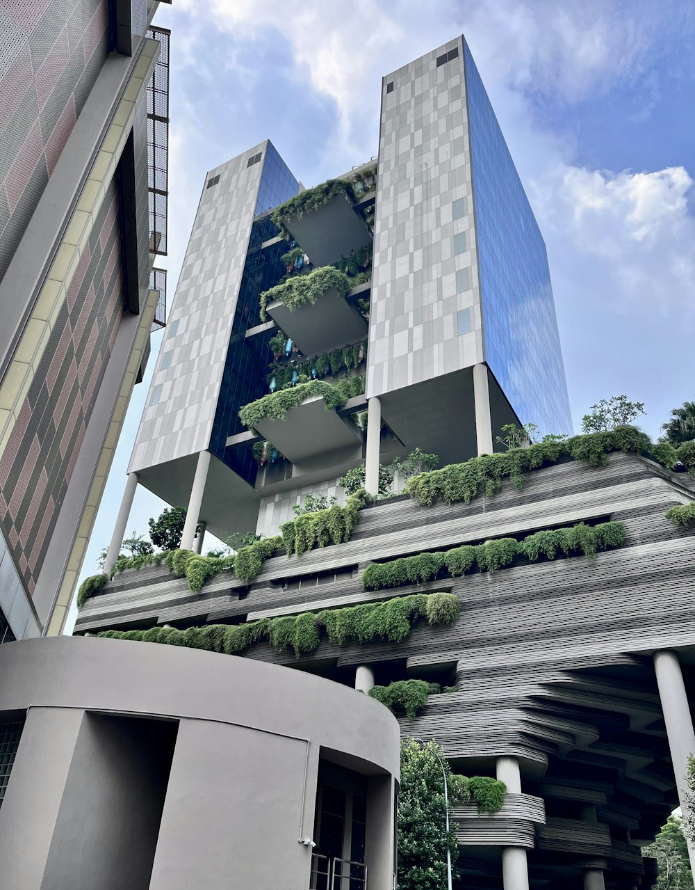 a very tall building with a bunch of plants growing on it