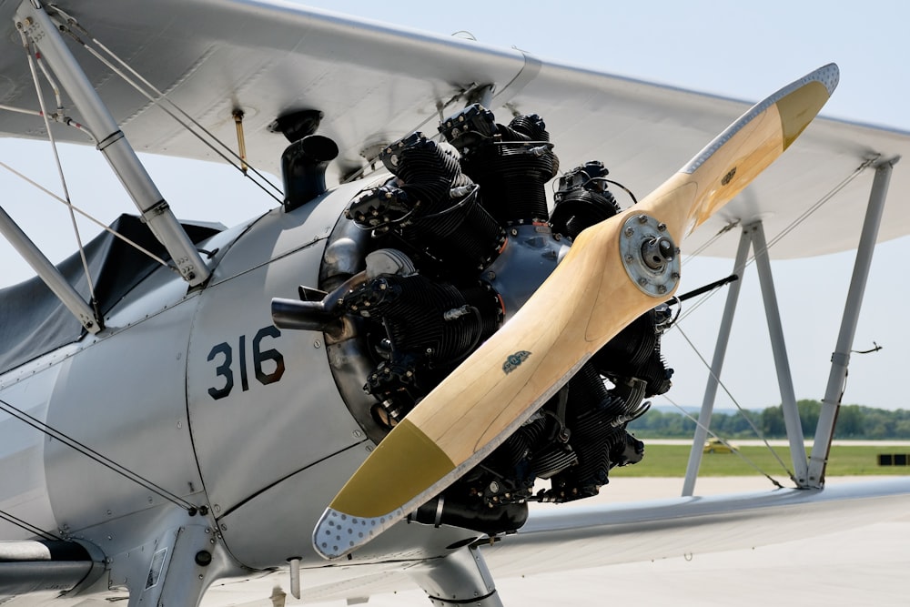 a close up of a propeller plane on a runway