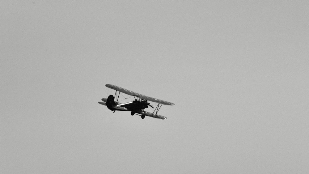 a small airplane flying through a cloudy sky