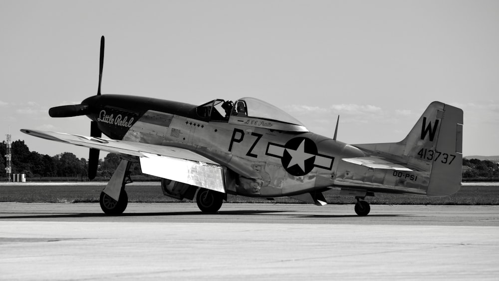 a black and white photo of a plane on a runway