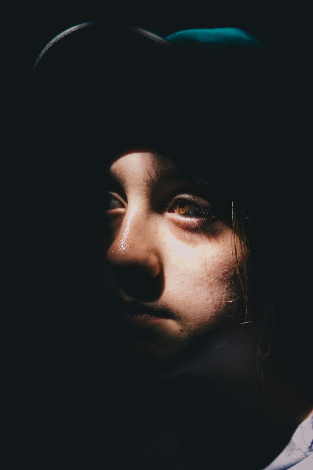 a woman's face is shown in the dark