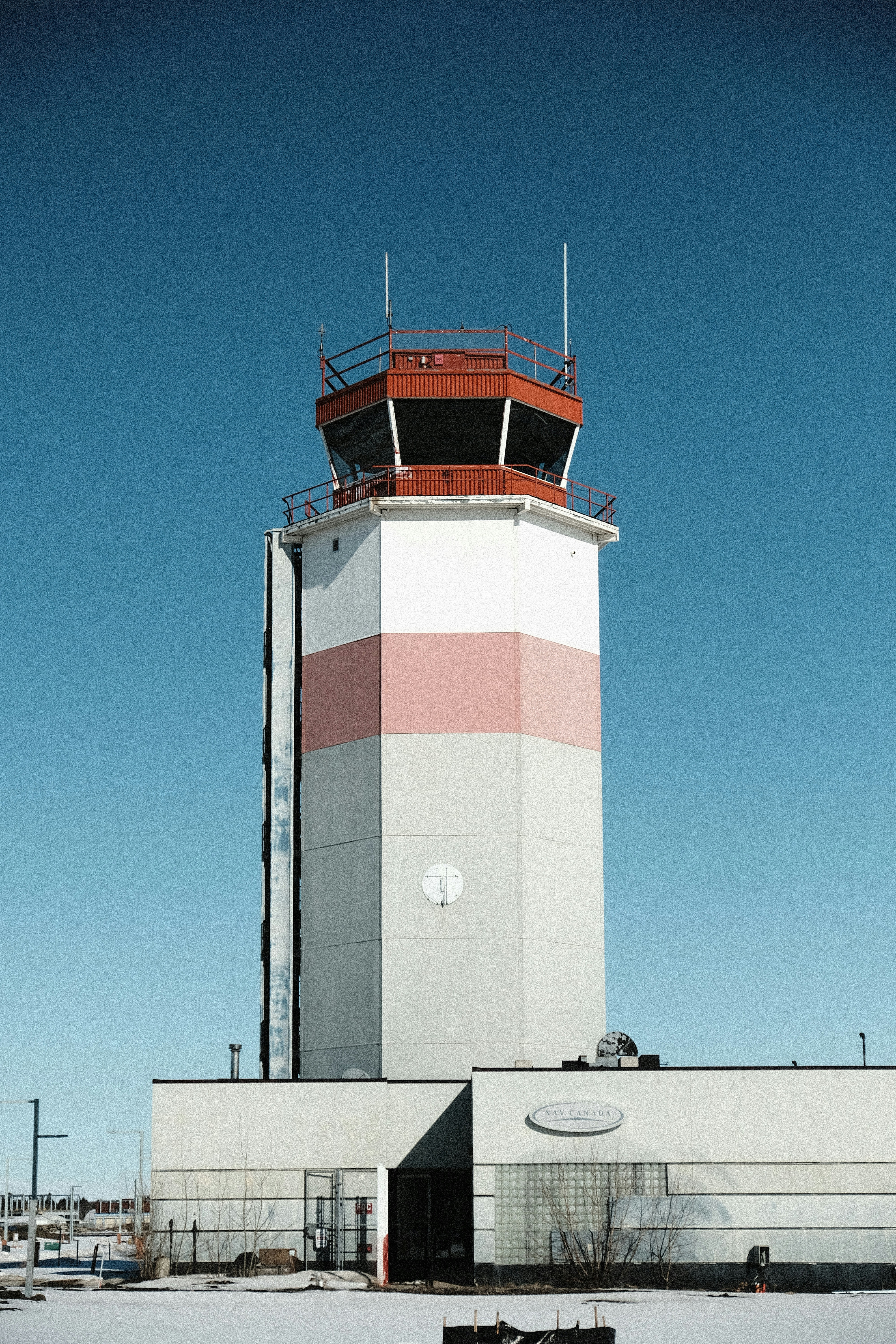 a large white tower with a red and white top
