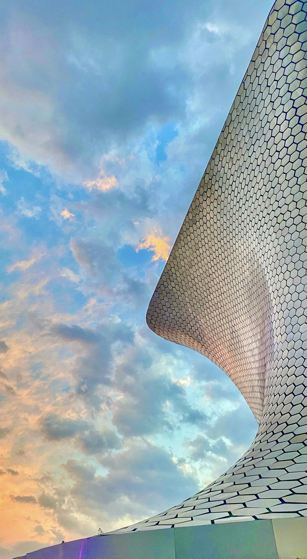 a tall building with a sky in the background