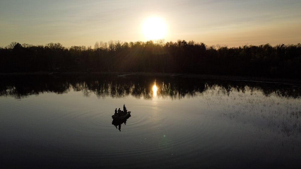 a small boat floating on top of a lake