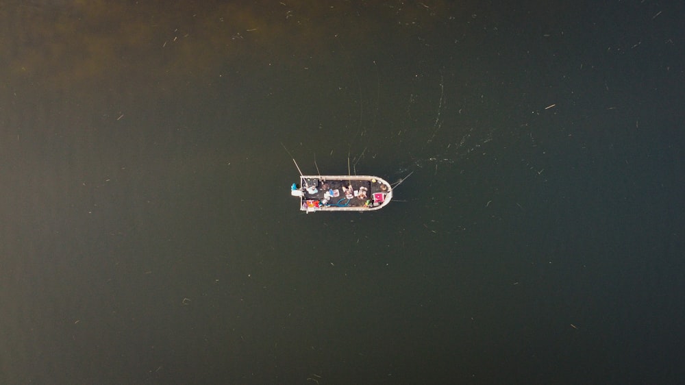 a group of people in a small boat on a body of water