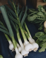 a bunch of onions and other vegetables on a table