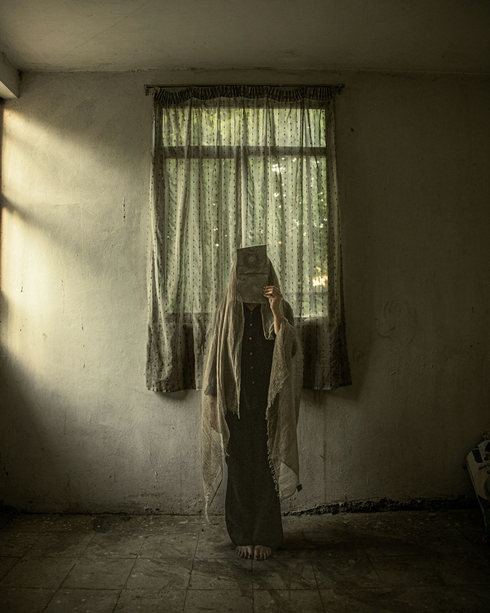 a woman standing in front of a window in a room
