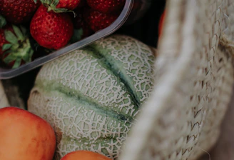 Fresh fruits in a wicker basket with morning light highlighting their natural colors.