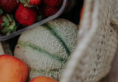 Fresh fruits in a wicker basket with morning light highlighting their natural colors.