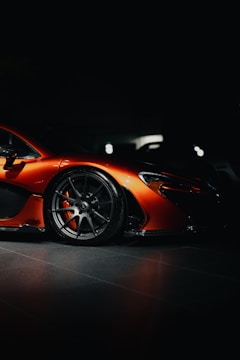 A bright orange sports car with a modern design.