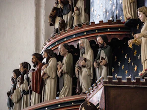 Close-up of intricately carved wooden figures from the famous Tischler-Krippe at Schlossbergplatz.