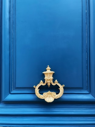 a blue door with a gold handle on it