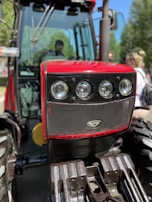 Agricultural tractor clutch system close-up with rugged terrain in the background.