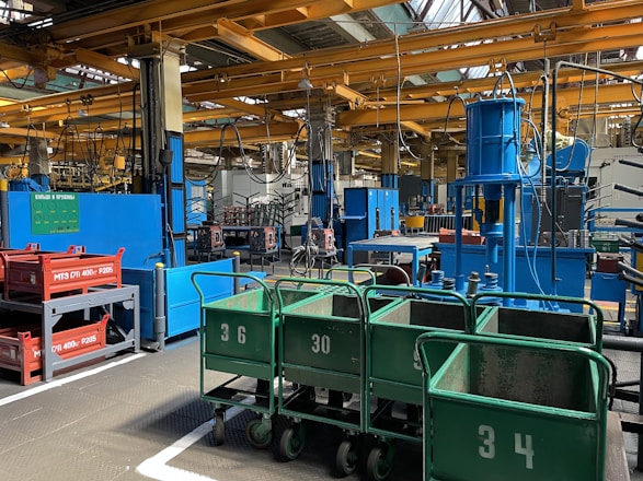Inside view of our manufacturing facility with overhead cranes and organized bays.