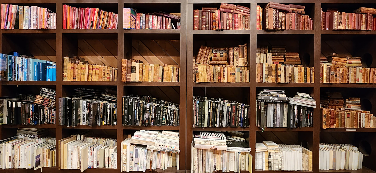 A densely filled bookcase seen straight on, spines in tight ranks