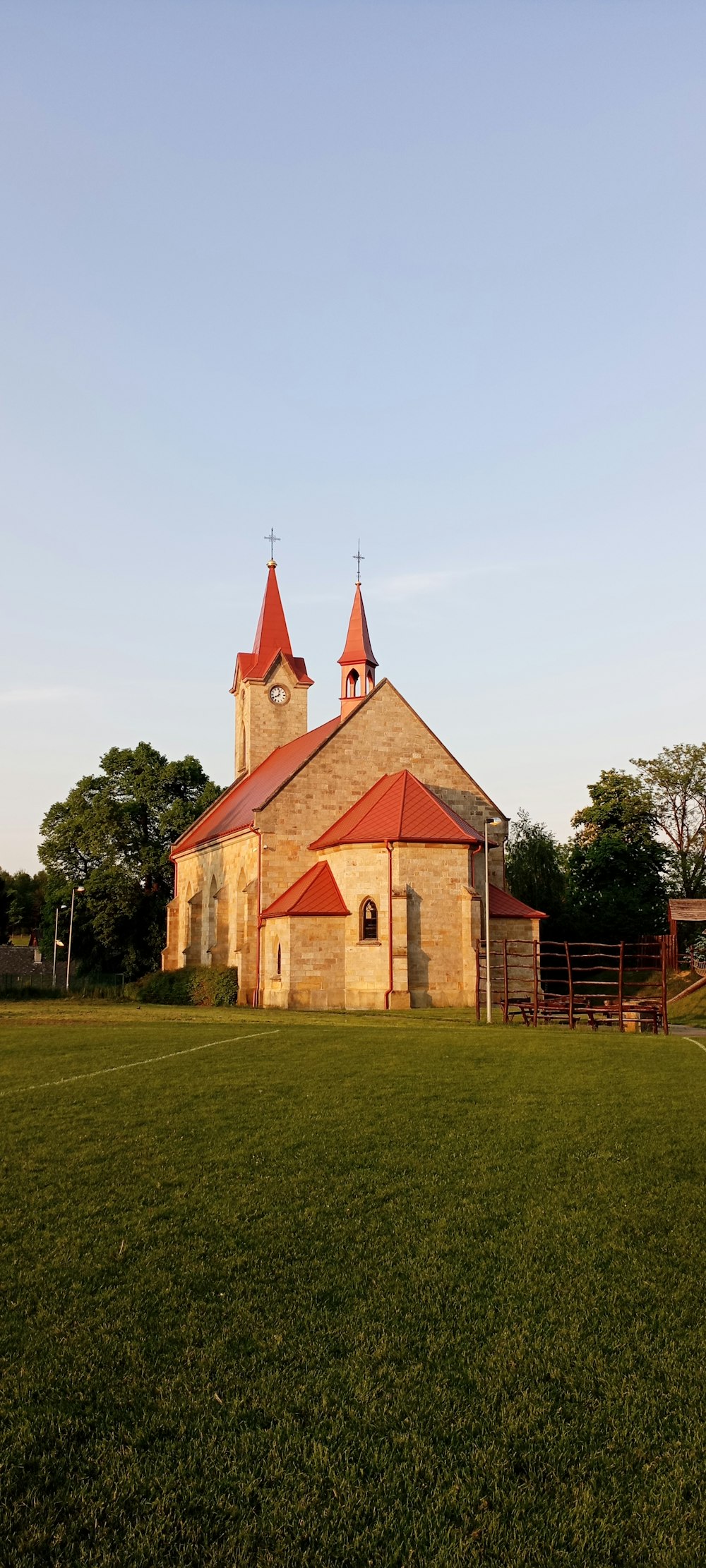 an old church with a red roof and steeple