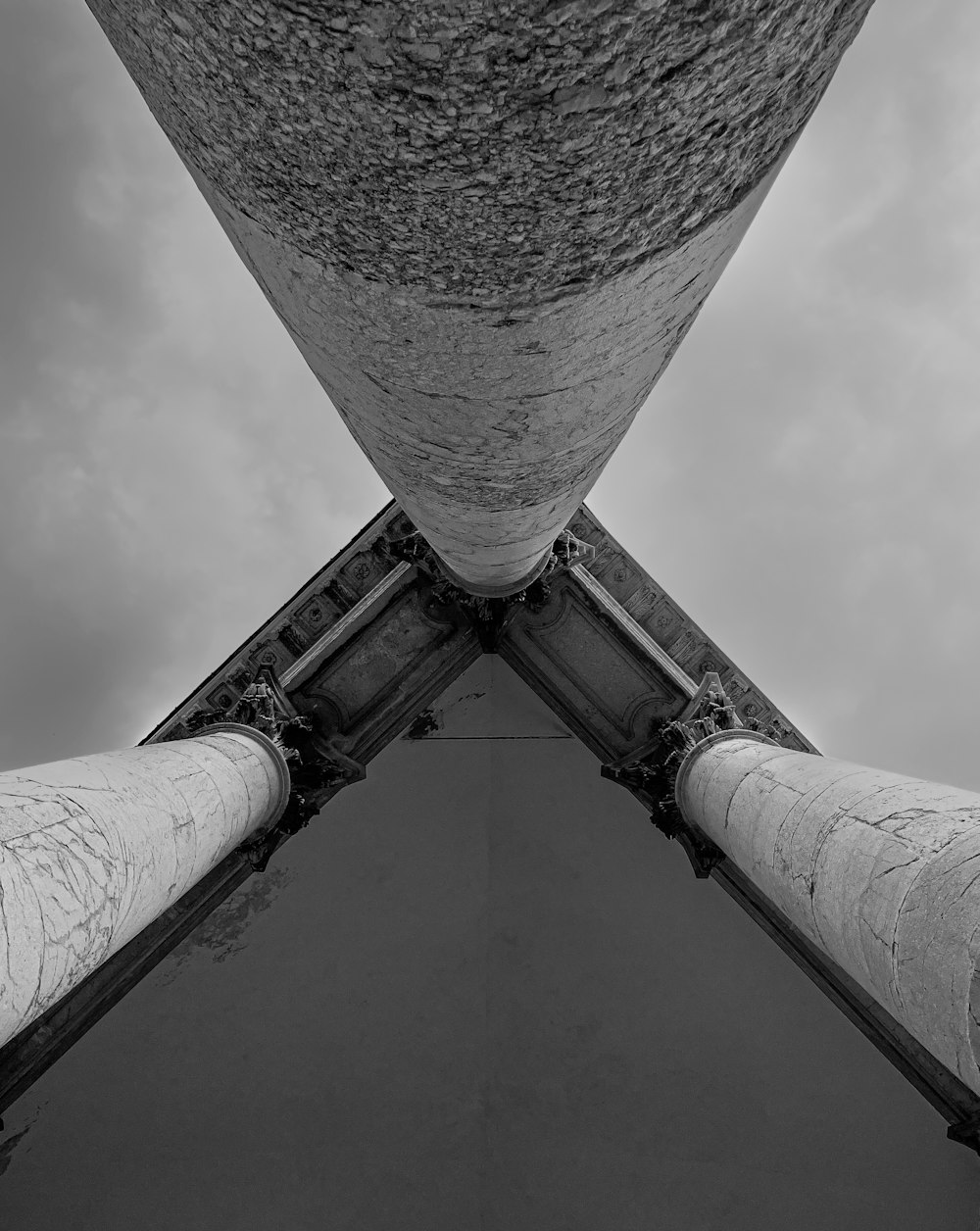 a black and white photo looking up at the top of a tower