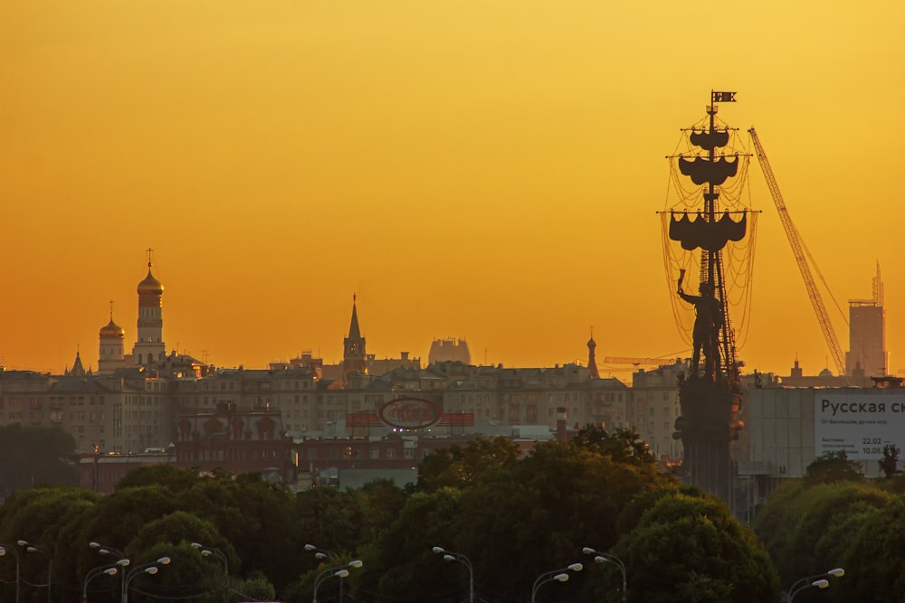 a city skyline with a ferris wheel in the foreground