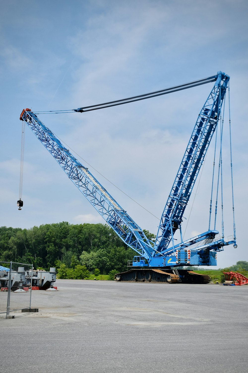 a large blue crane sitting on top of a parking lot