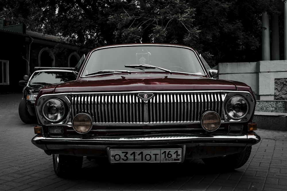 a red car parked on a brick road