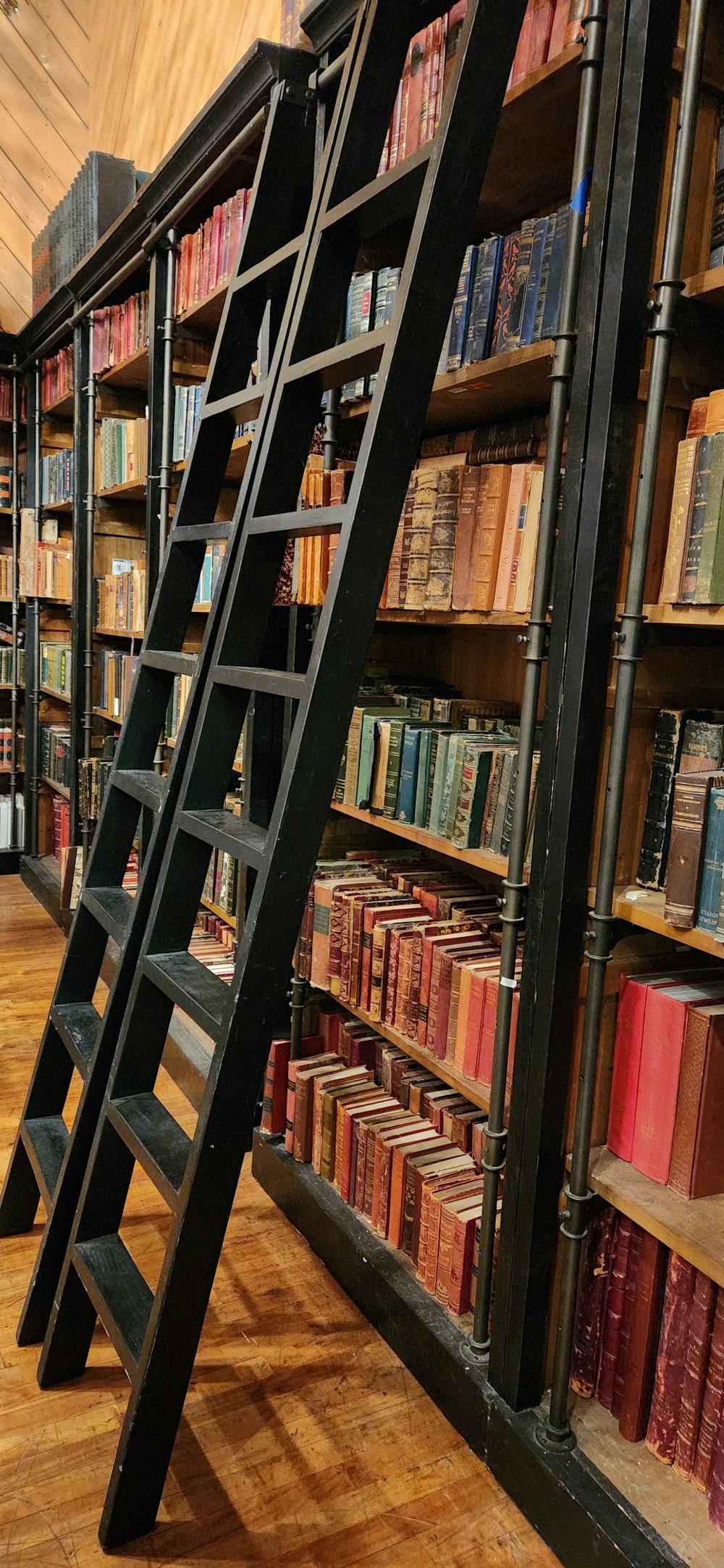 a ladder leaning against a bookshelf in a library