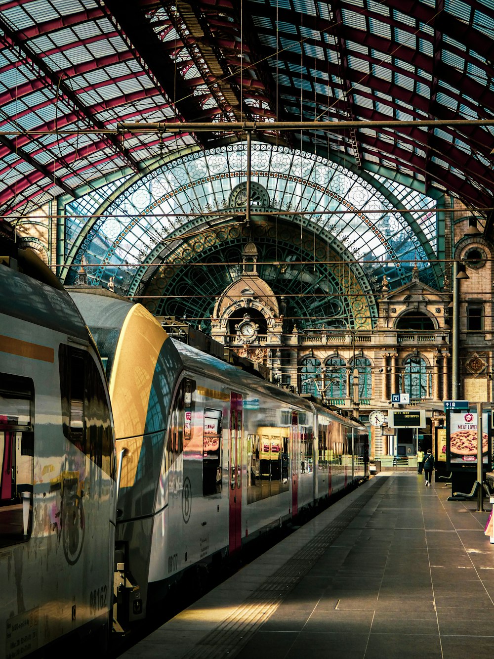 a train station with two trains parked next to each other