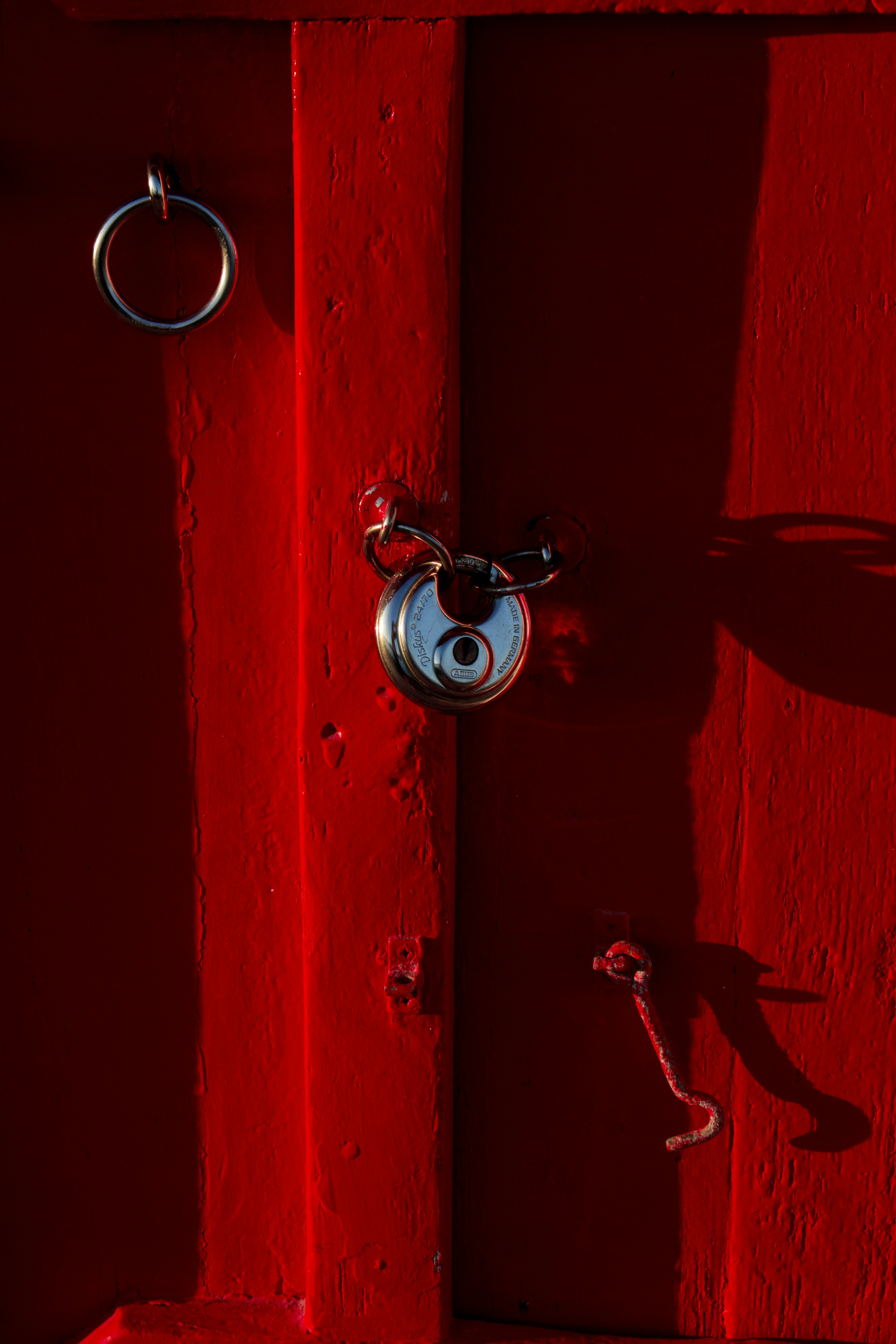 A red door with a ring on the handle photo Free Paint Image on Unsplash