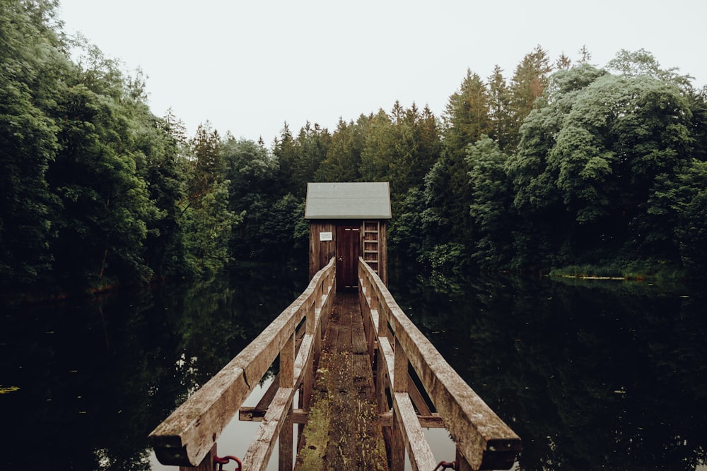 a wooden dock with a small building on top of it