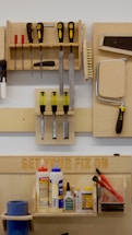 a workbench with tools hanging on the wall