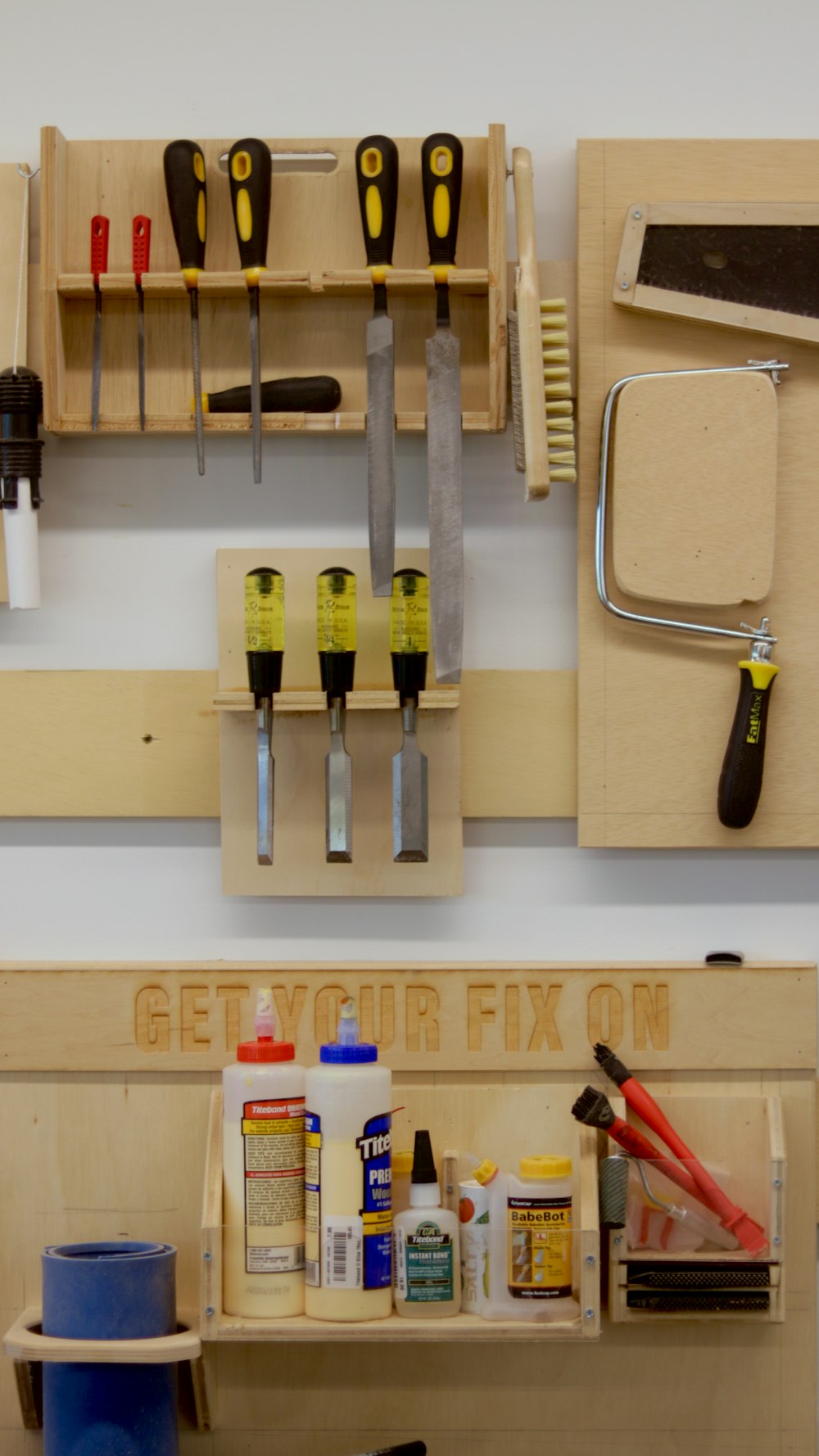 a workbench with tools hanging on the wall