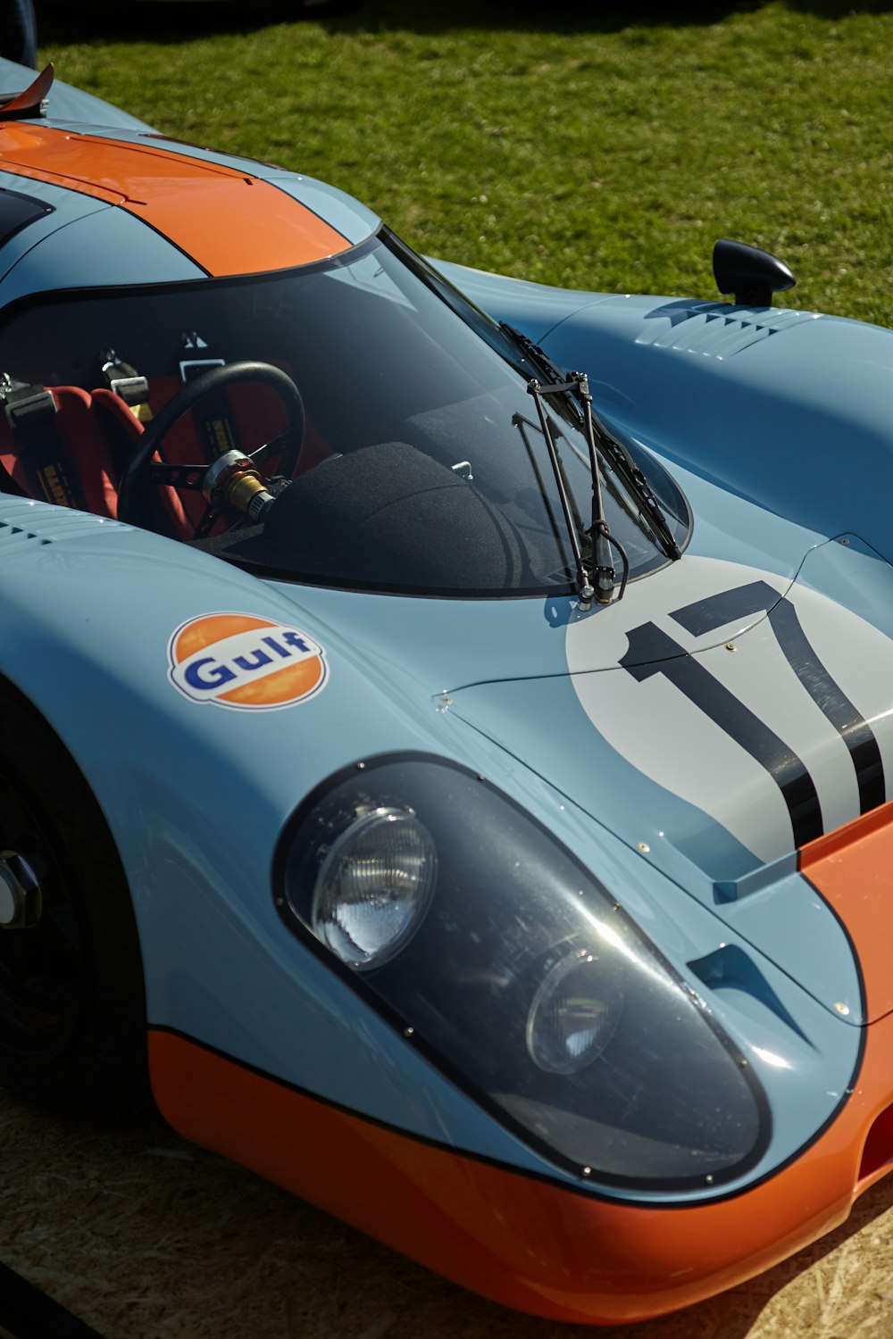 a blue and orange race car parked in a parking lot