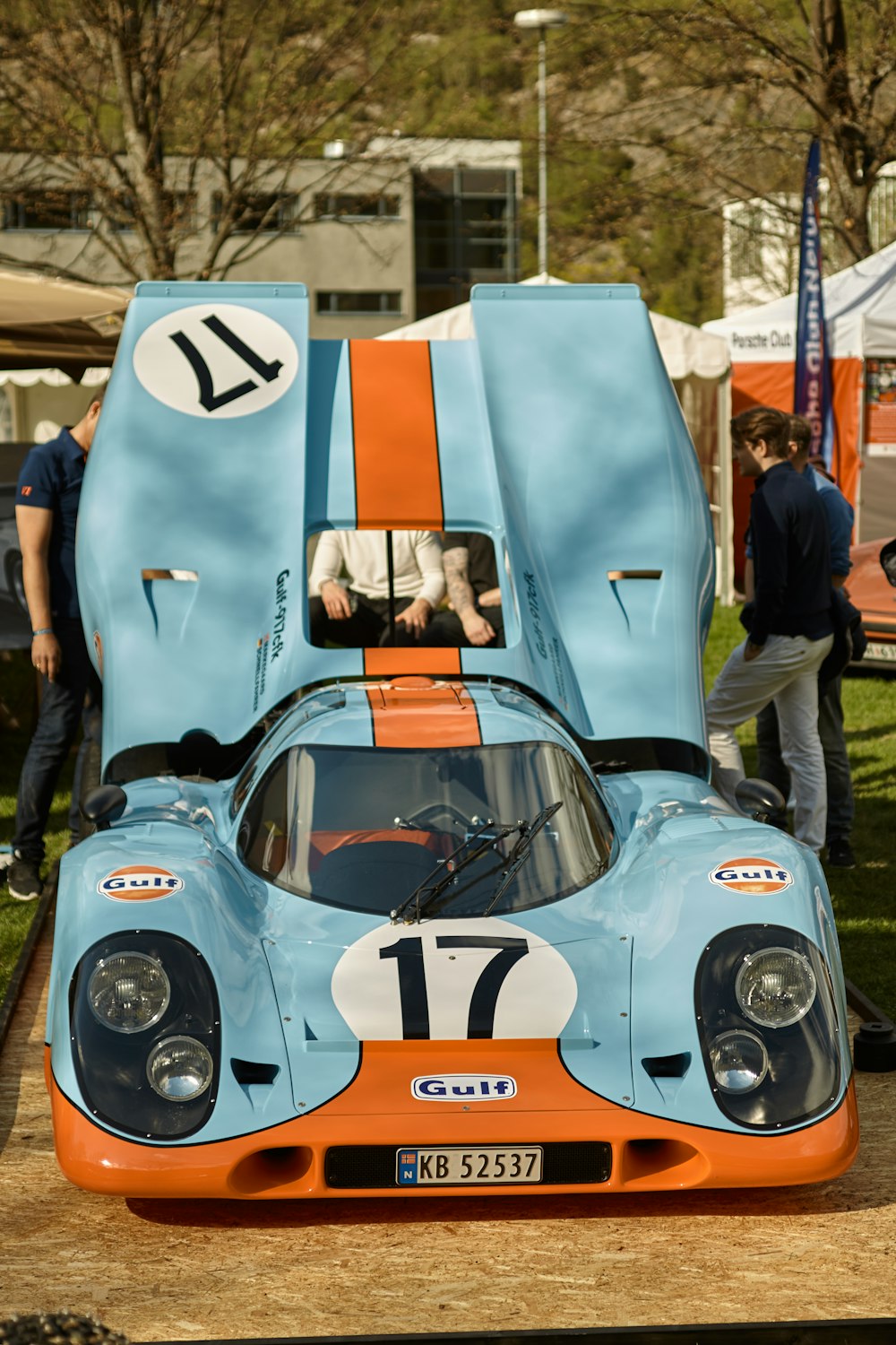 an orange and blue race car parked in a parking lot