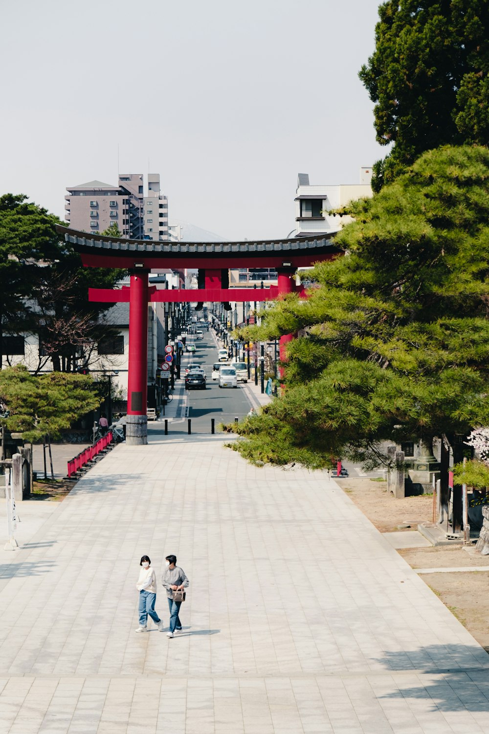 a couple of people walking down a walkway