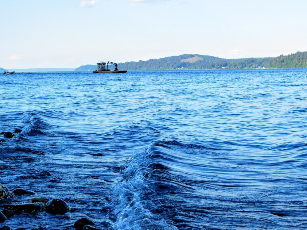 a boat is out on the water near the shore