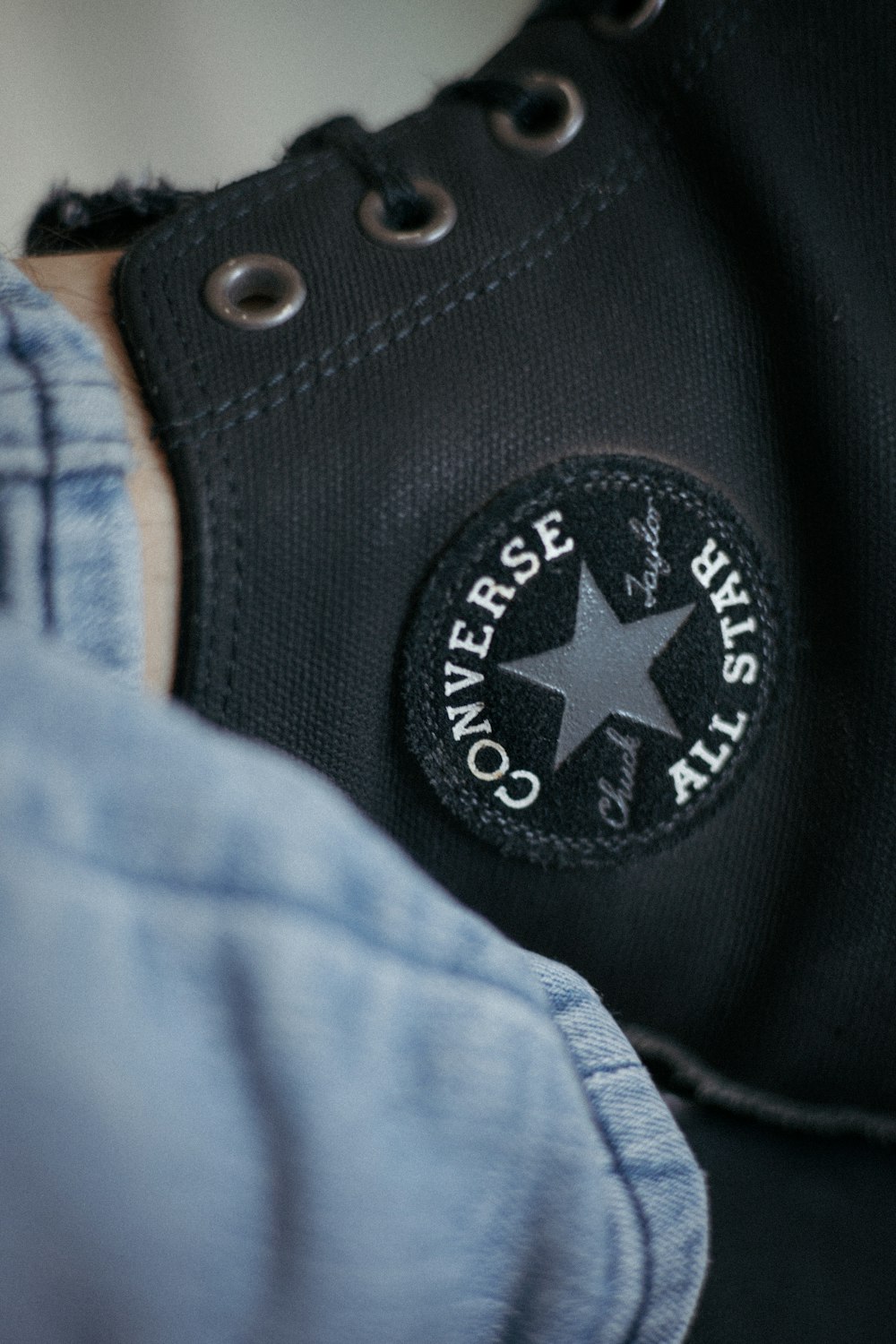 A pair of black converse shoes with a star on the side photo – Free Jeans  Image on Unsplash