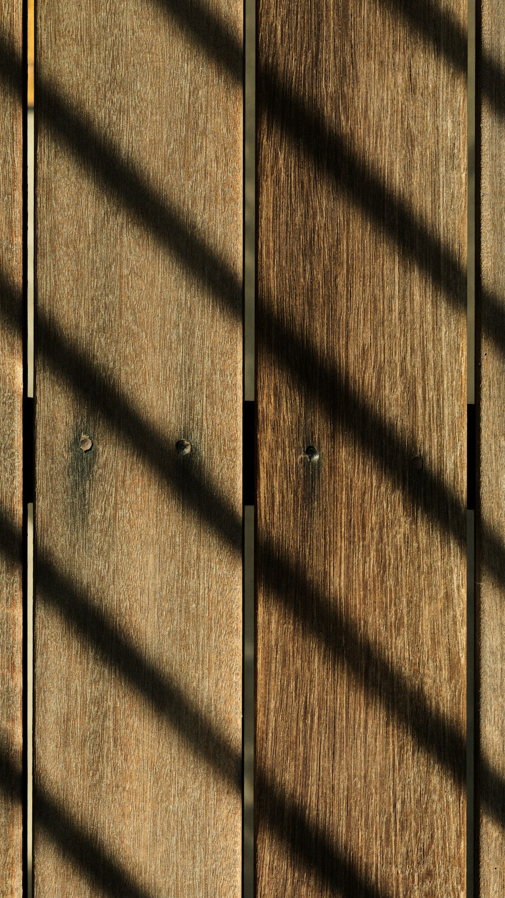 a close up of a wooden door with a metal handle