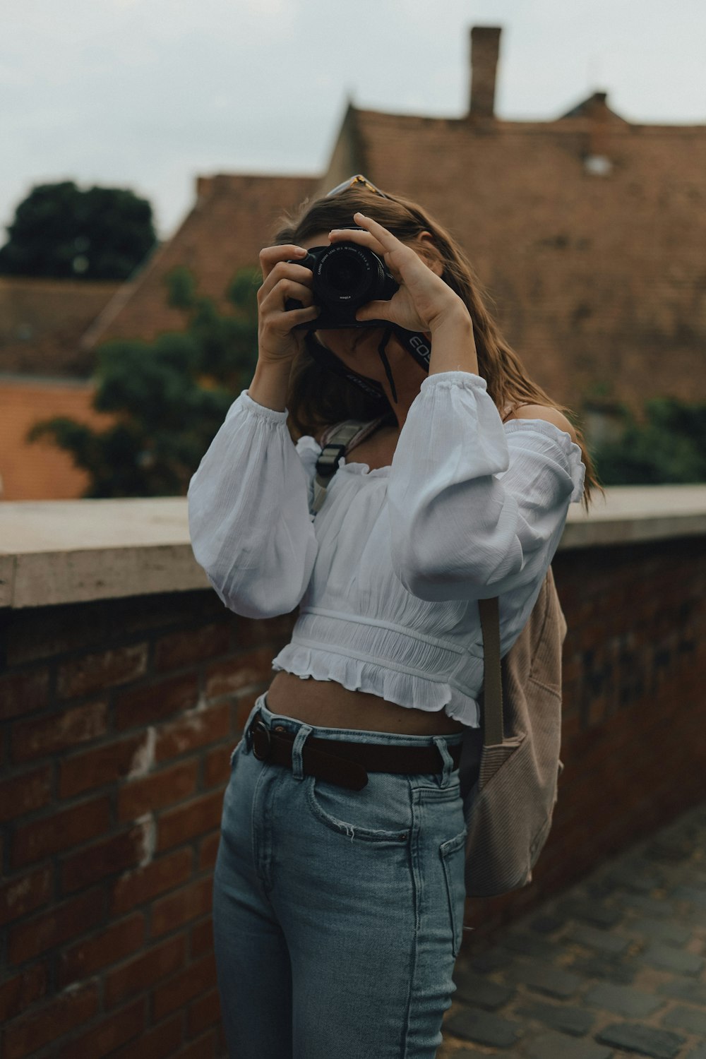 a woman taking a picture of herself with a camera