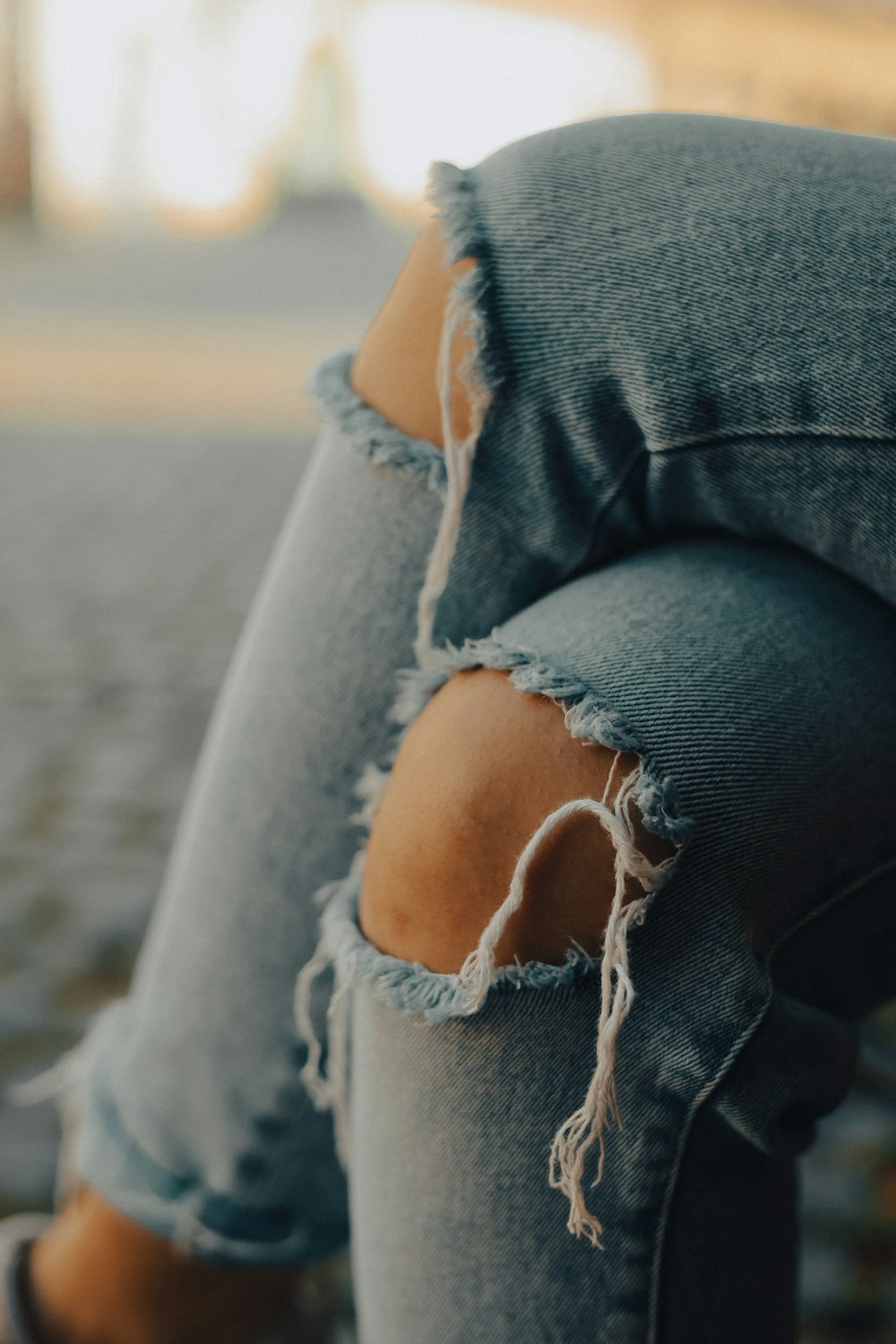 a woman's ripped jeans with a hole in the back