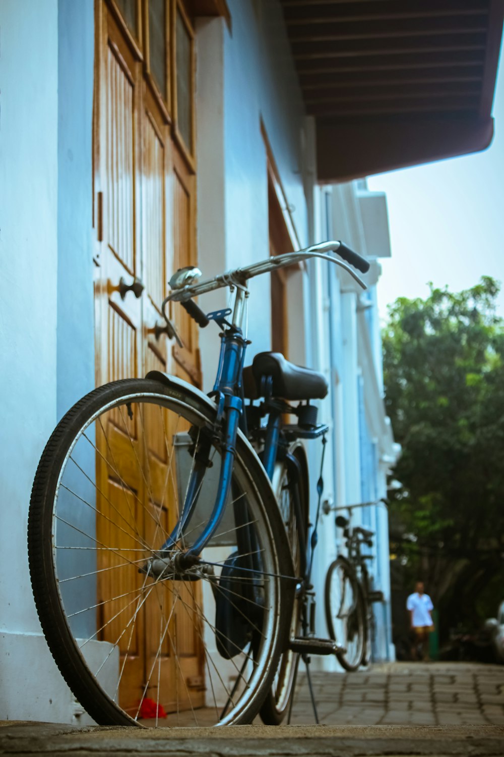 a blue bicycle parked on the side of a building