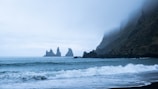 A misty morning scene of Iceland's rugged coastline at sunrise.