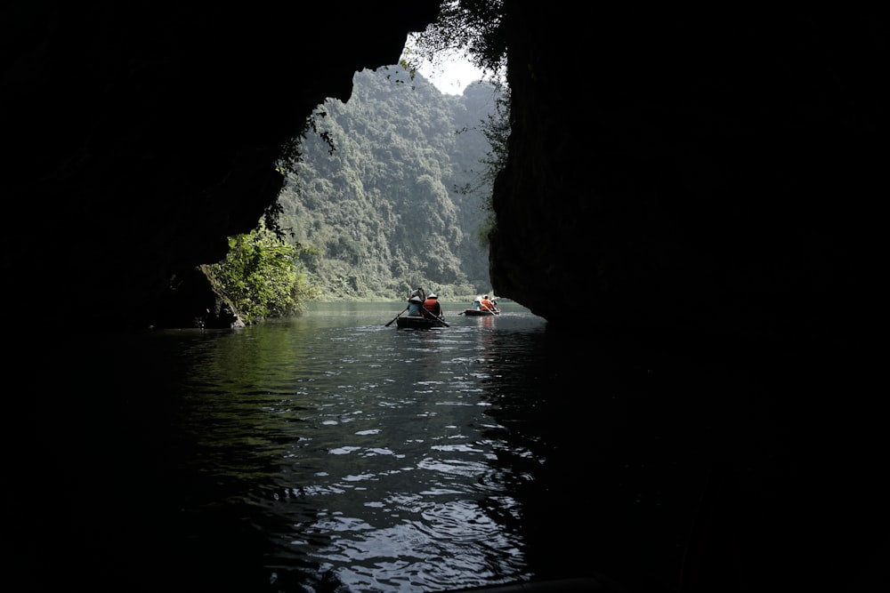 a group of people in a canoe in a cave