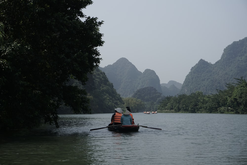 a person in a canoe paddling down a river