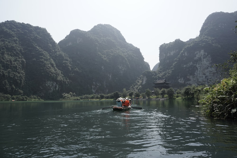 two people in a small boat on a river