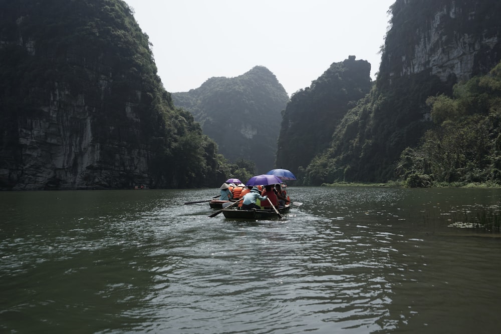 a group of people riding on top of a boat down a river