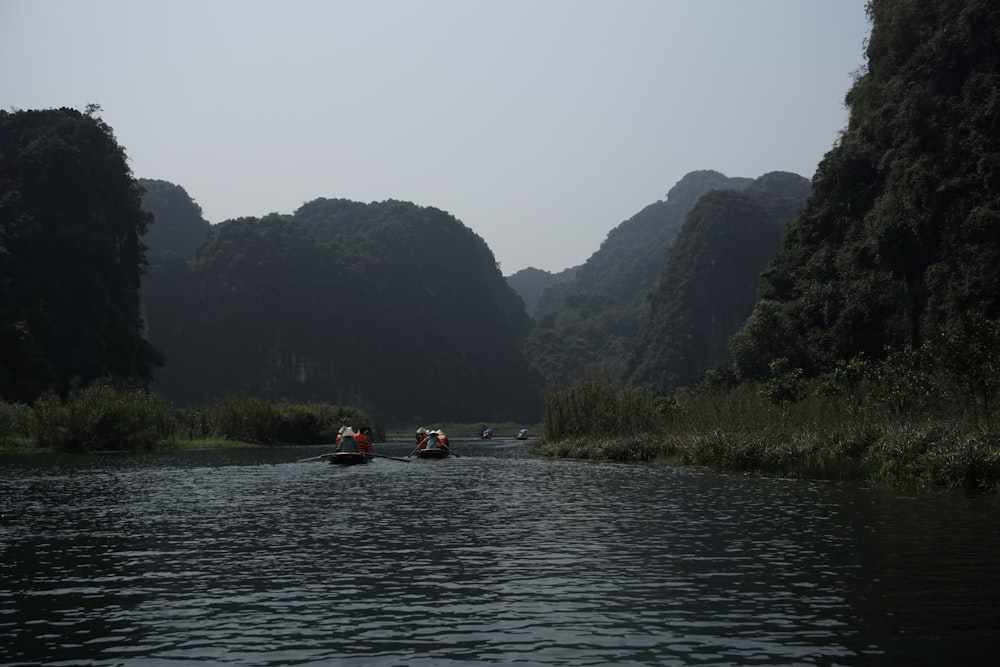 a group of people in small boats on a river