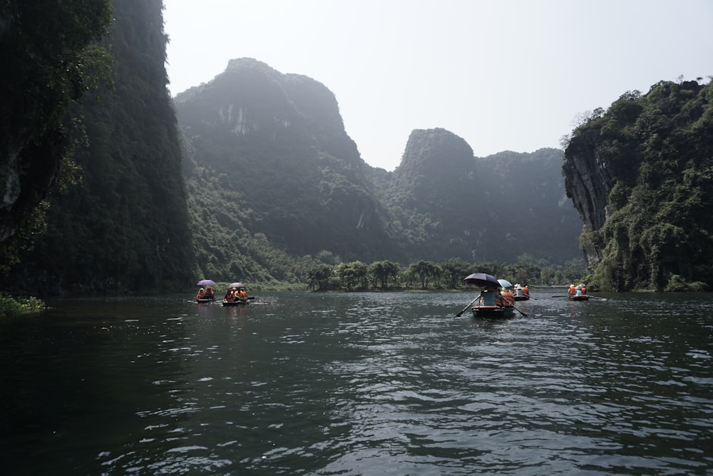 a group of people in small boats on a river